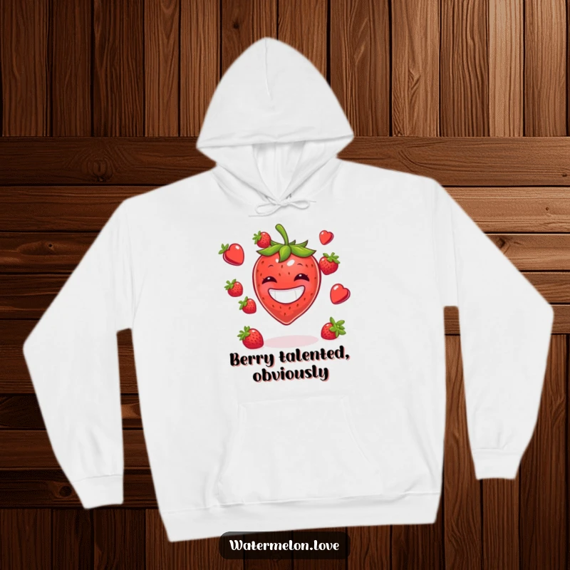 Funny hoodie displaying a grinning strawberry juggling a pile of berries, perfect for cozy, humorous wear.