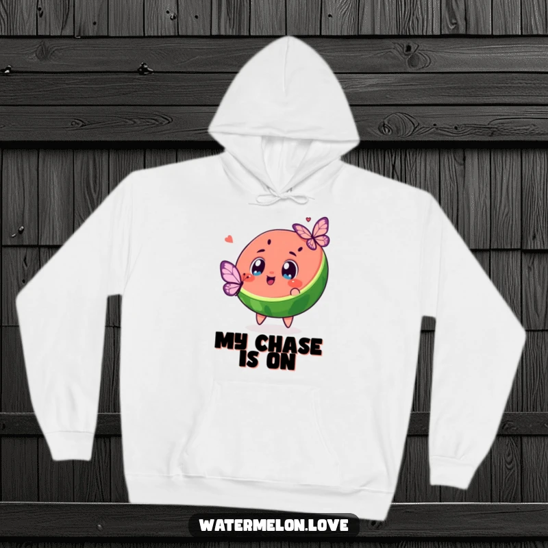 Funny and warm hoodie featuring a kawaii watermelon slice with excited eyes chasing a butterfly, embodying playful wonder.