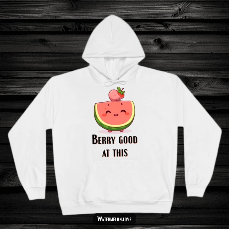 Happy watermelon slice hoodie perfectly balancing a tiny, smiling berry on its head, showcasing a heartwarming bond of fruit friends.