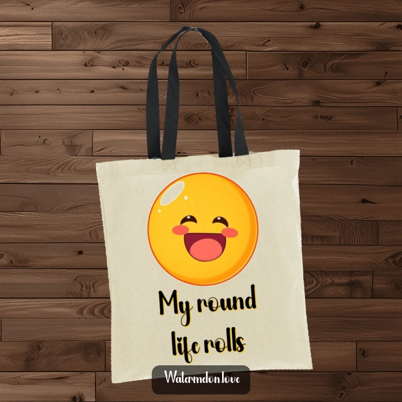 Funny rolling orange tote bag, a round fruit character laughing heartily while tumbling.